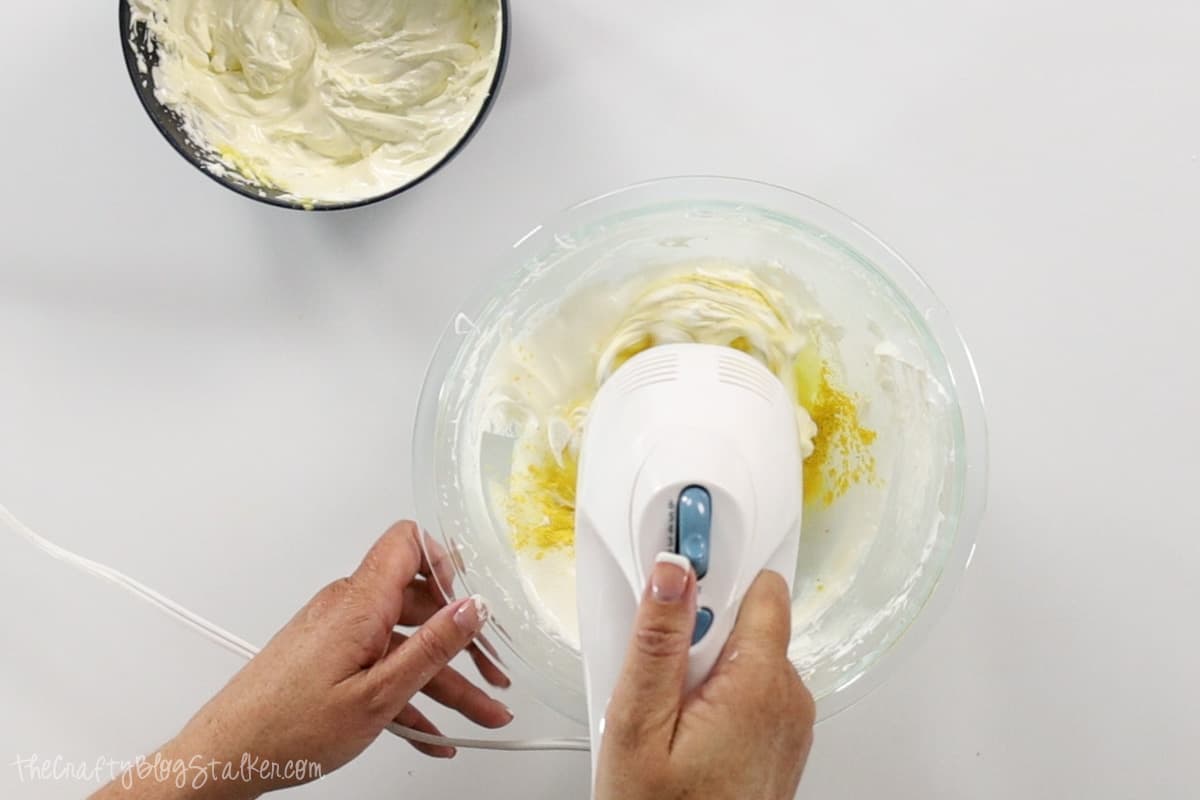Whipping a soap mixture with yellow mica powder.