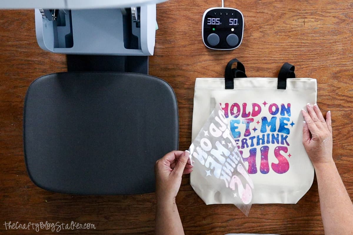 Removing the Cricut Infusible Ink transfer Sheet from the tote bag.