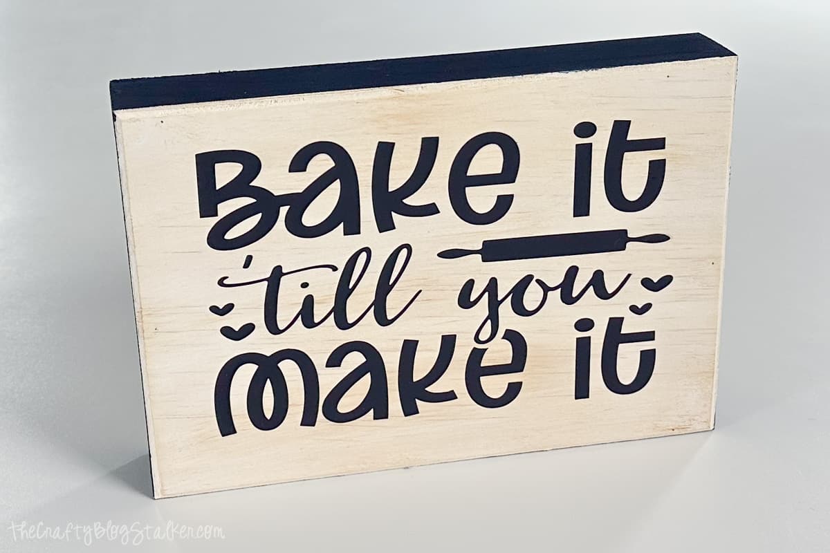 A kitchen sign that reads 'bake it till you make it'.