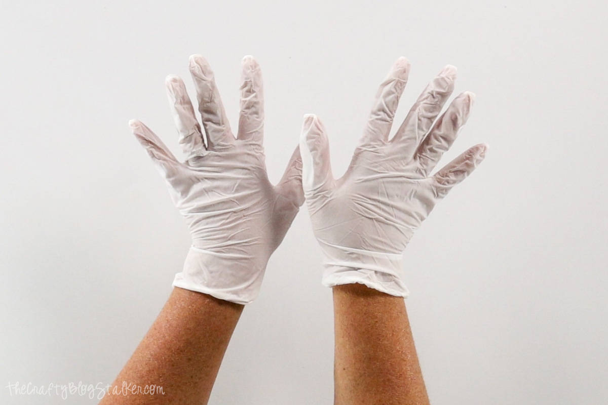 Hands wearing food safe gloves.