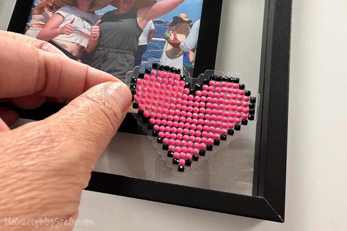 Placing a sticker on a photo frame.