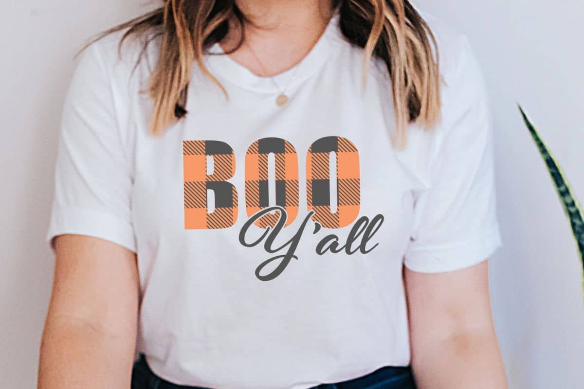 Woman wearing a shirt with a design that reads Boo Y'all.
