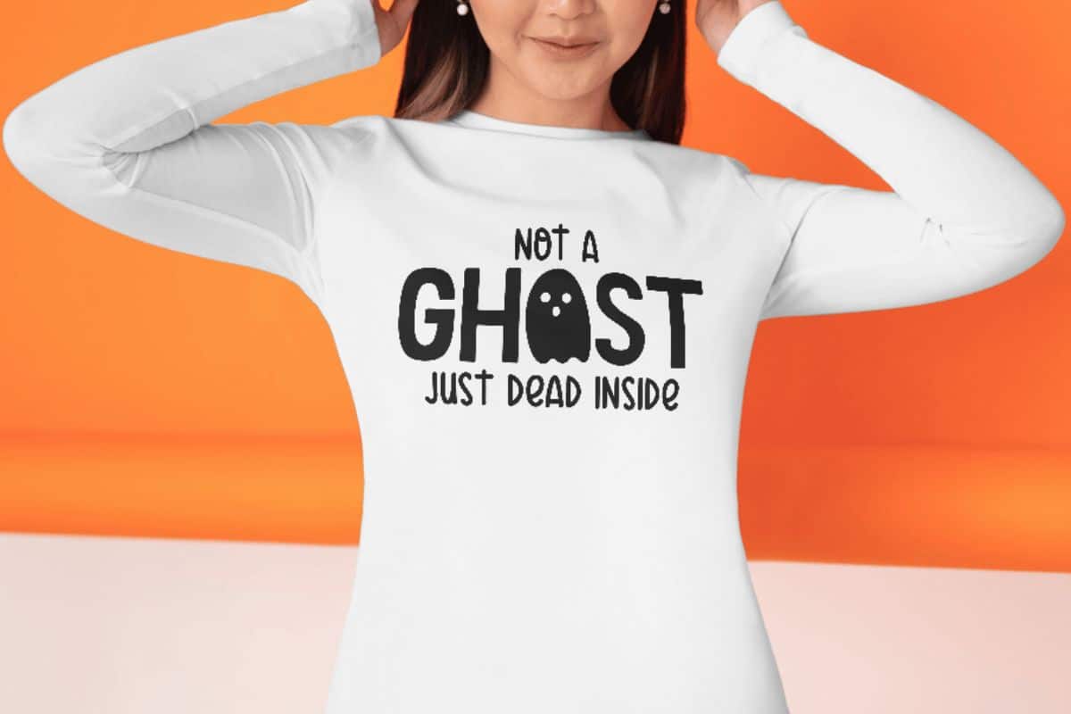 Woman wearing a shirt with the design - Not a ghost just dead inside.