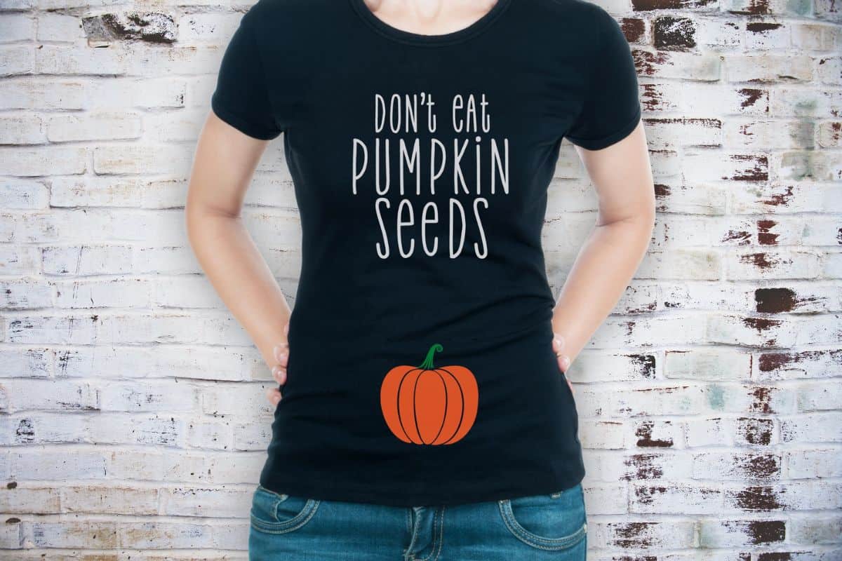 Pregnant woman wearing a shirt with the design - Don't eat pumpkin seeds.