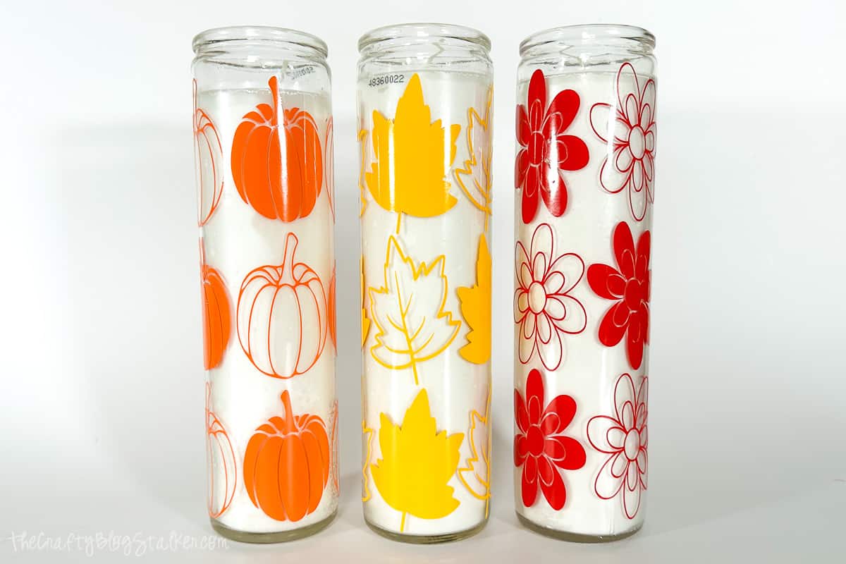 3 dollar tree prayer candles turned into fall candles with pumpkin, leaf, and flower designs.