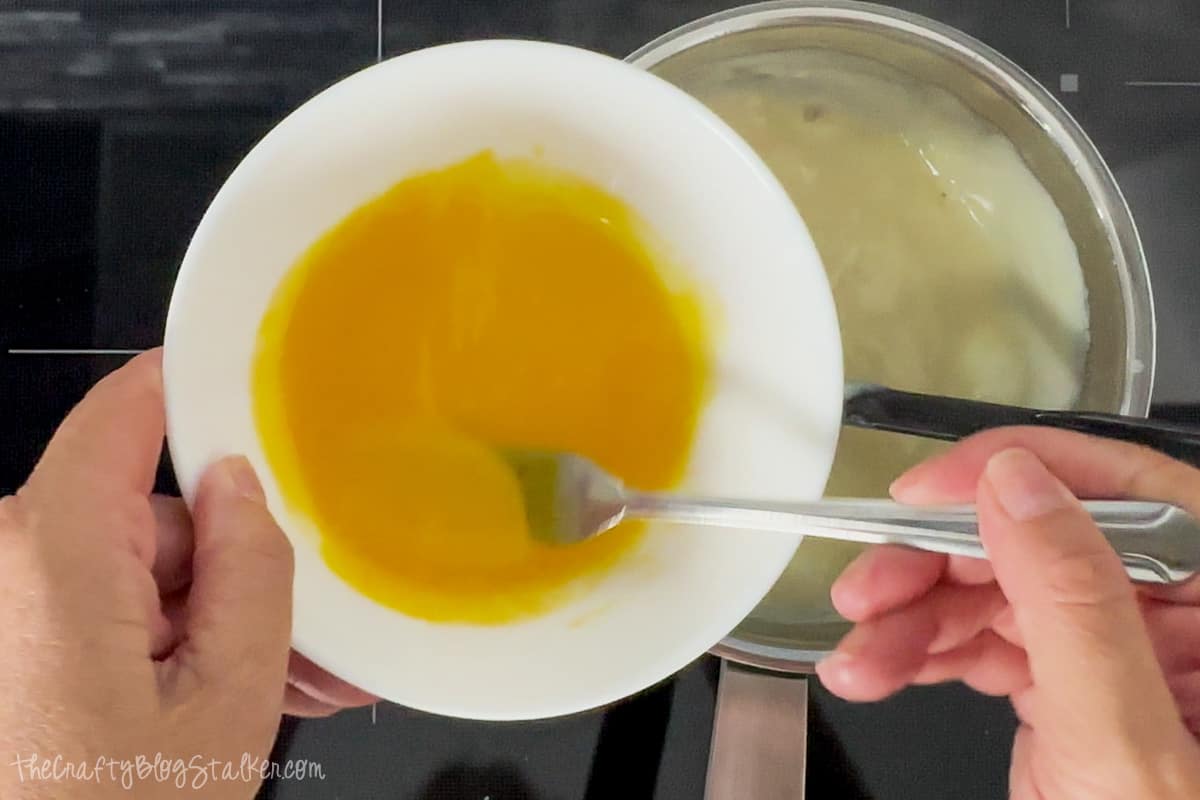 3 egg yolks slightly beaten in a bowl.