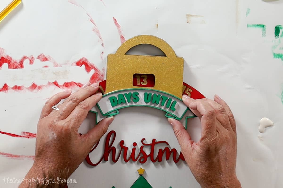 Gluing ornament topper into place.