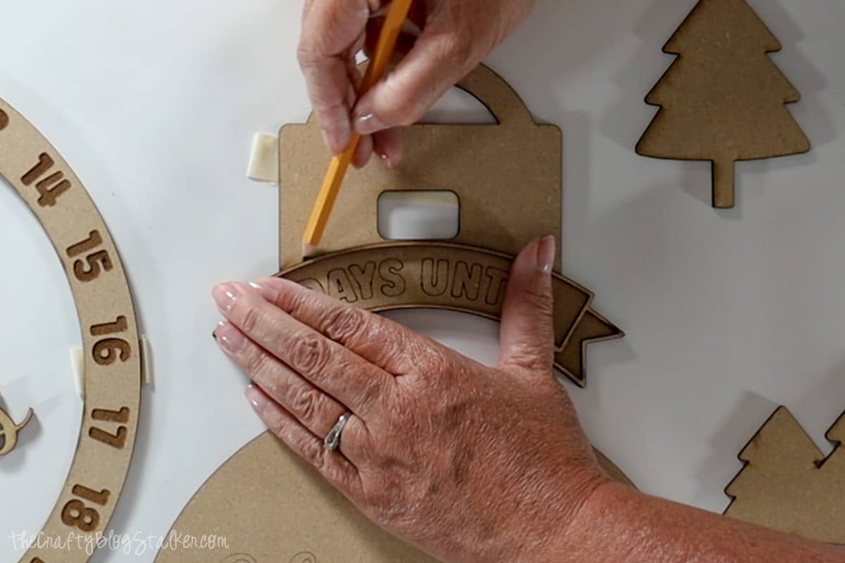 Tracing a line onto the ornament topper.