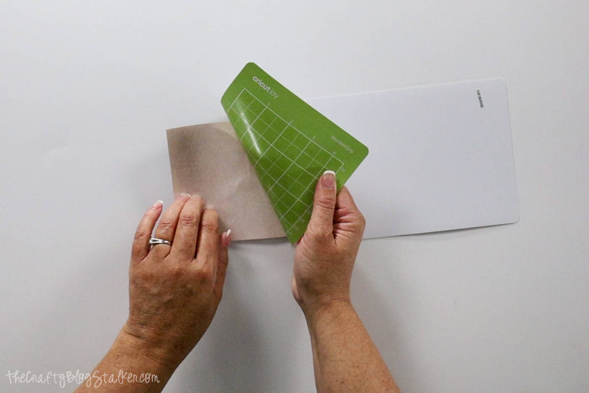 Removing the mat from the Infusible Ink Sheet after cutting.