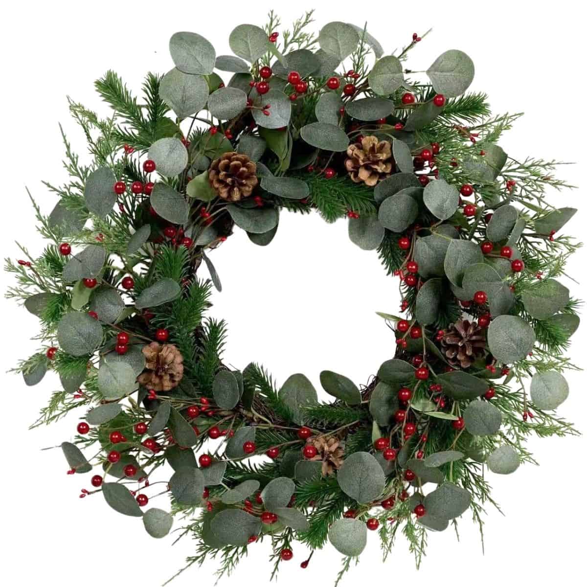 Christmas wreath made of eucalyptus leaves, pine branches, red berries, and pinecones arranged in a natural, festive circular design.