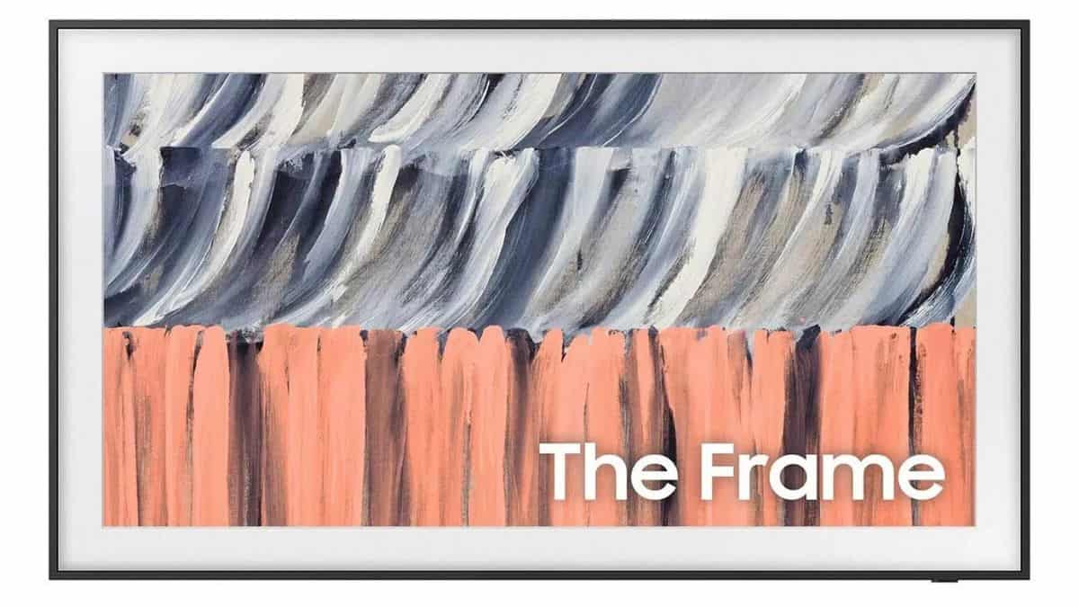 Samsung The Frame TV displaying abstract artwork with gray, white, and coral brushstrokes, surrounded by a slim black frame.