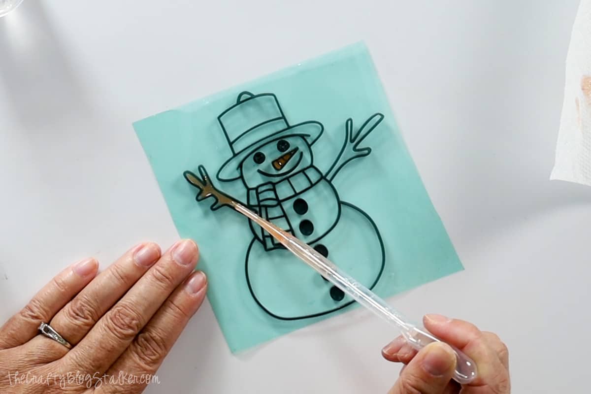 Adding brown resin to the snowman twig arms.