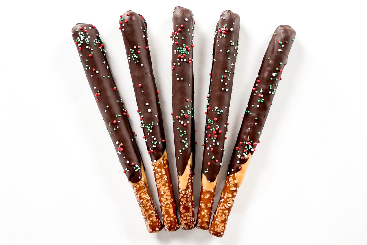 Five delicious chocolate covered pretzel rods.