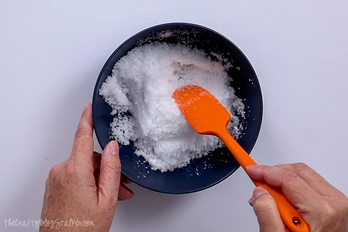 Stirring the salt mixture with a spatula.