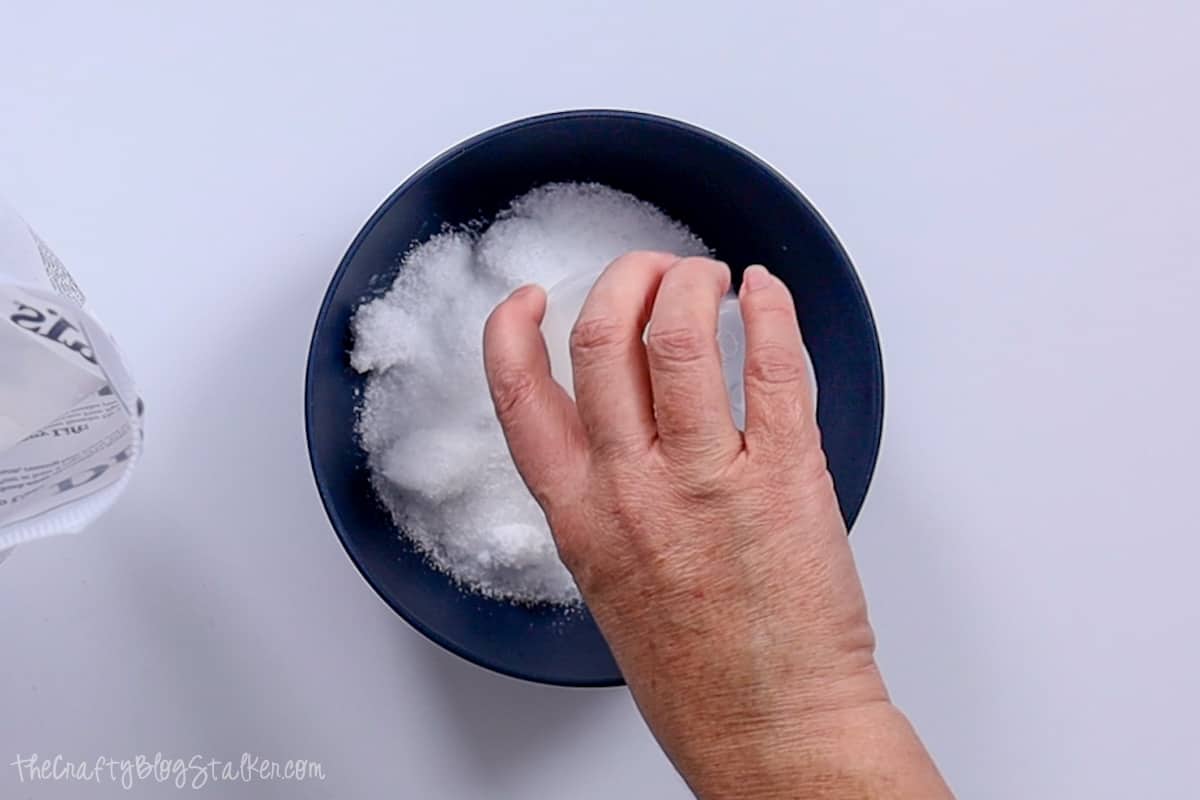 Adding a cup of Epsom Salt to a bowl.