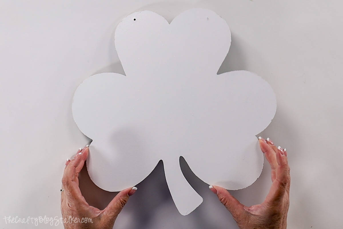 Shamrock door hanger painted with white spray paint.