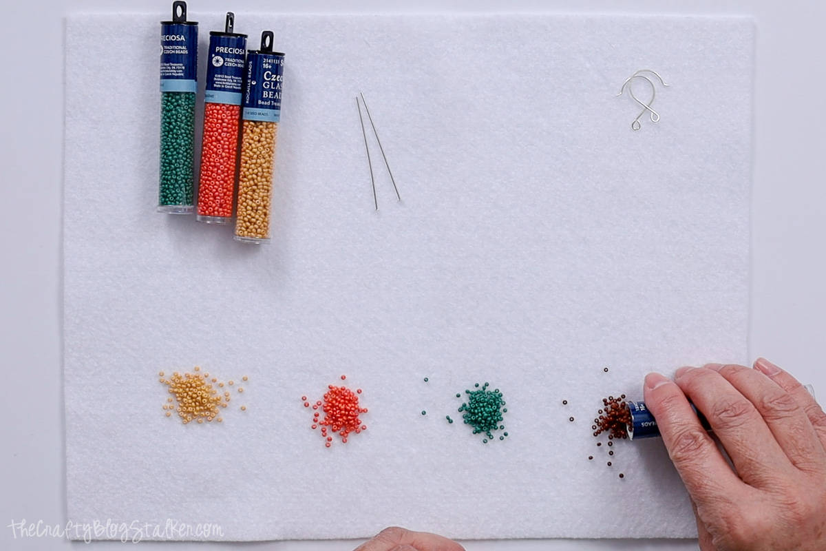 Pouring seed beads onto a felt mat.