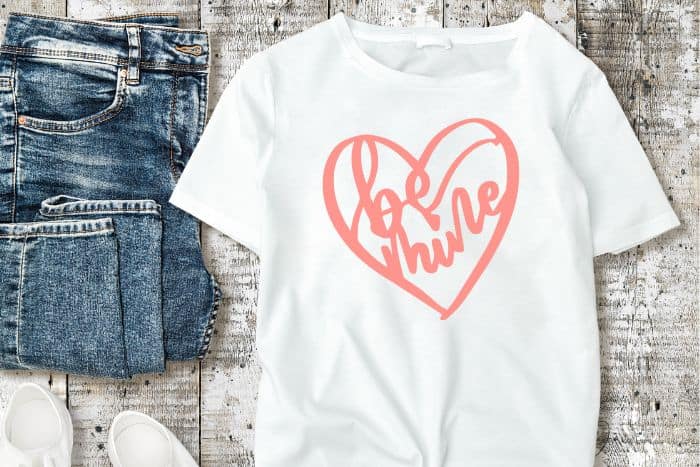 A child's white t-shirt with a Be Mine design.