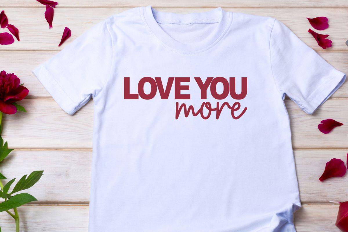 White t-shirt with a design that reads "Love You More".