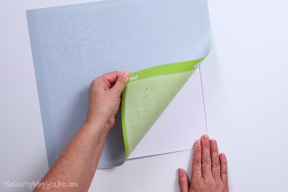 Removing the mat from the cut paper.
