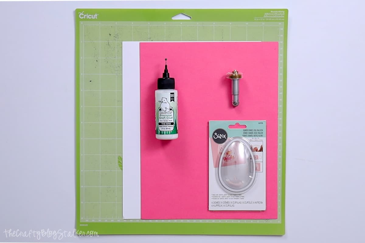StanrdGrip Cricut Mat, pink and white cardstock, precision glue, and sizzix shaker domes.