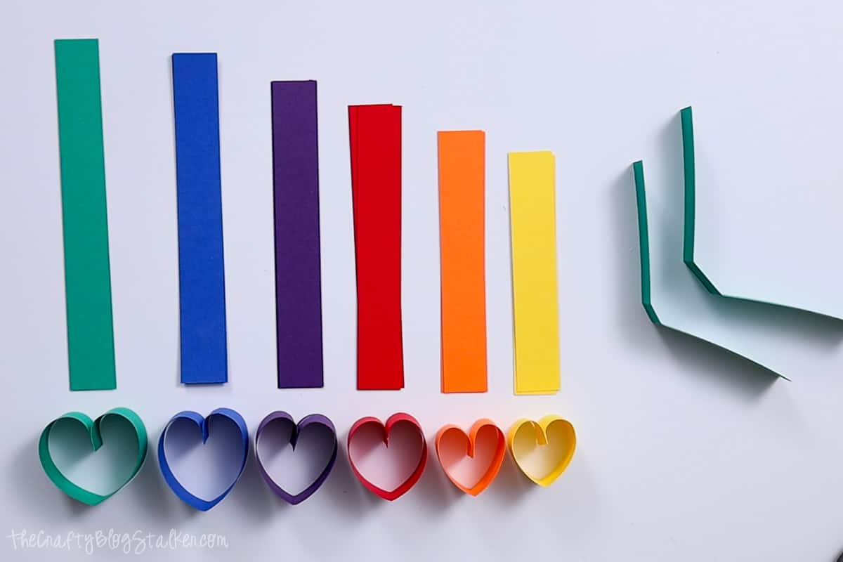 Hearts made from strips of paper in a rainbow of colors.