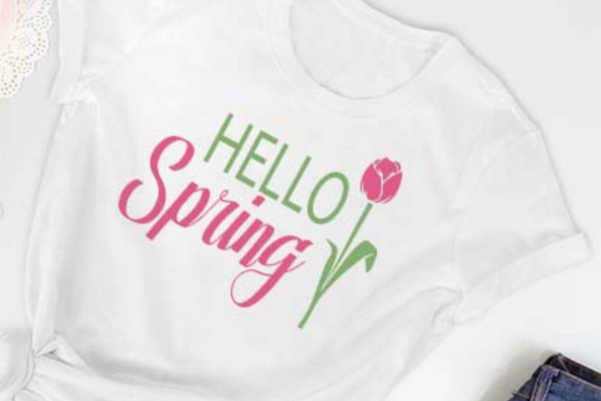White t-shirt with an svg design that reads hello spring with a tulip.
