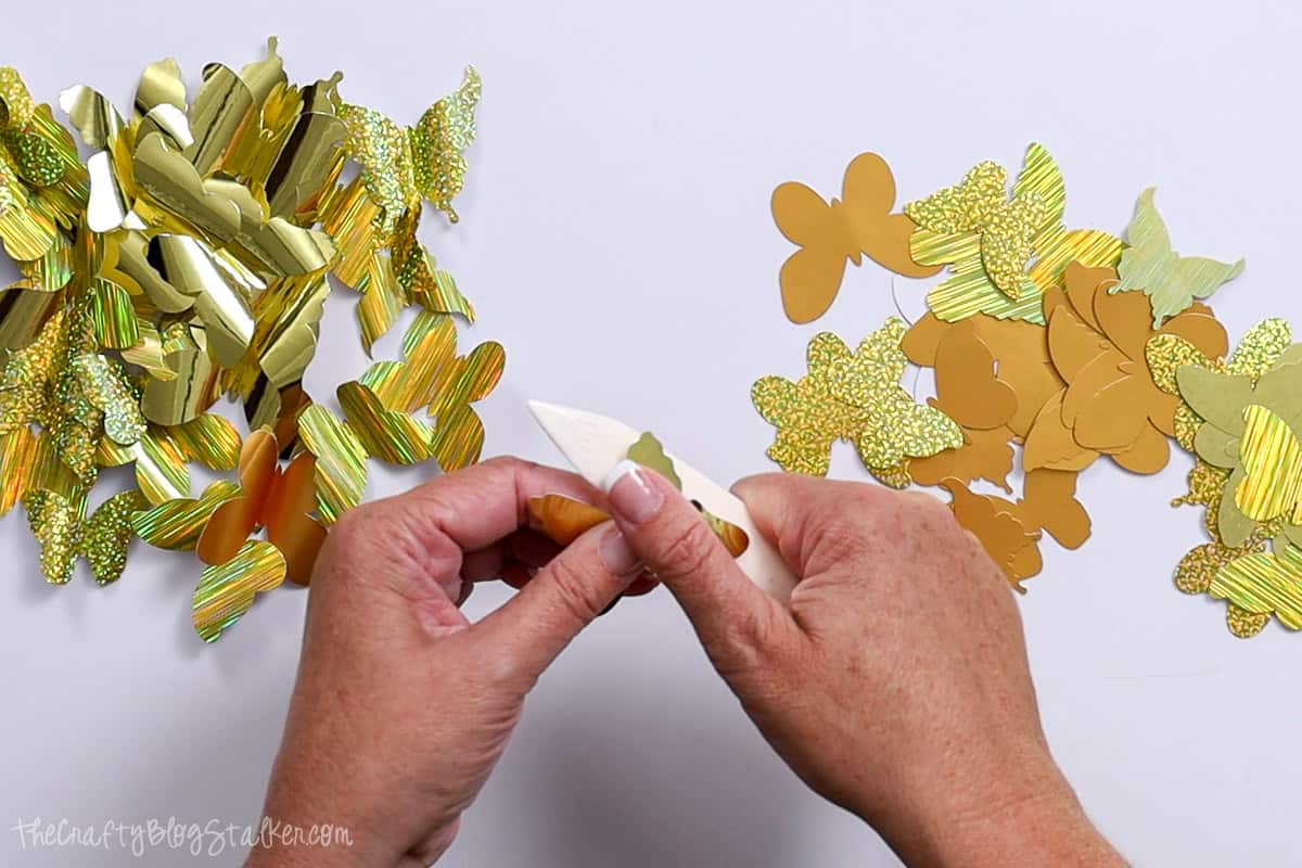 Shaping Butterfly wings with a bone folder.