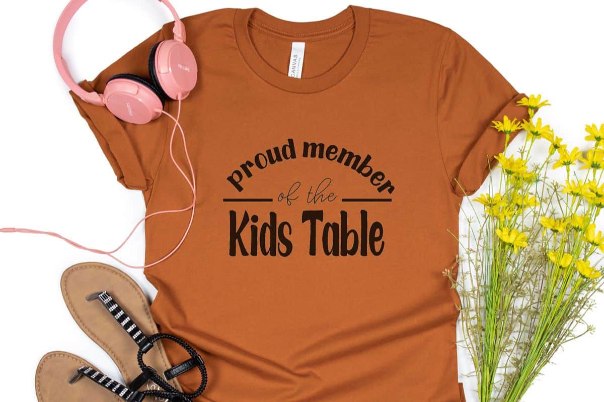 Burnt orange shirt with the design - proud member of the kids table.