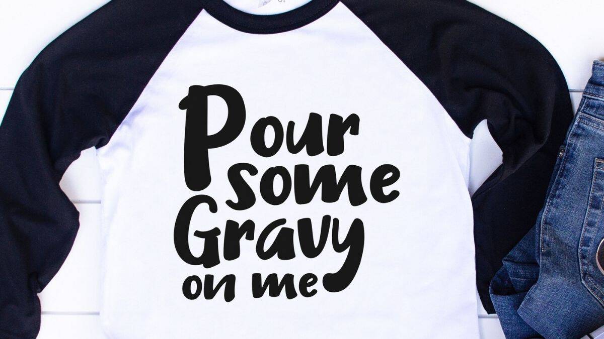 White and black raglan shirt with the phrase 