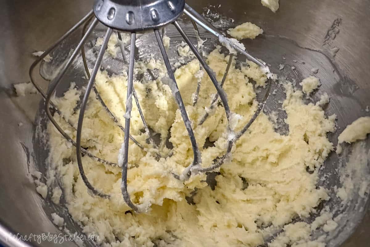 Combining butter and sugar in a mixing bowl.