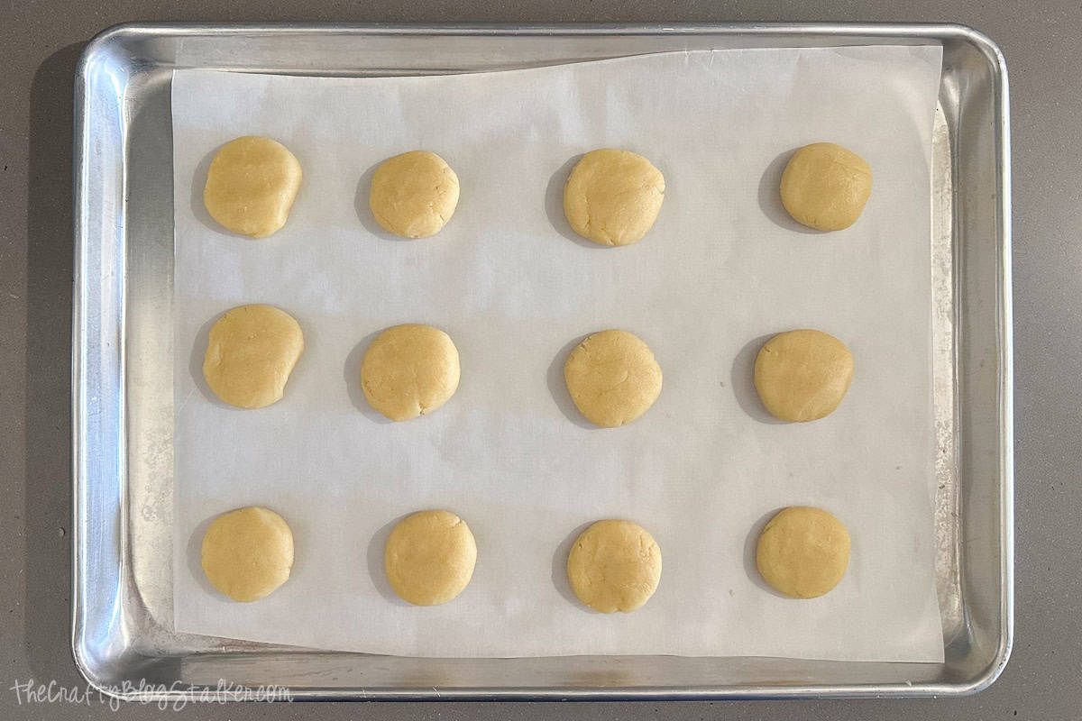 Dough balls slightly flattened with the palm of a hand.