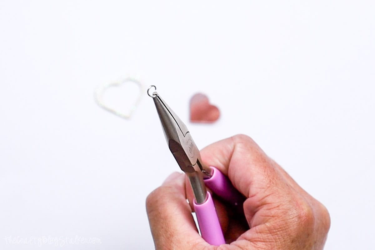 An open jump ring help with a pair of pliers.