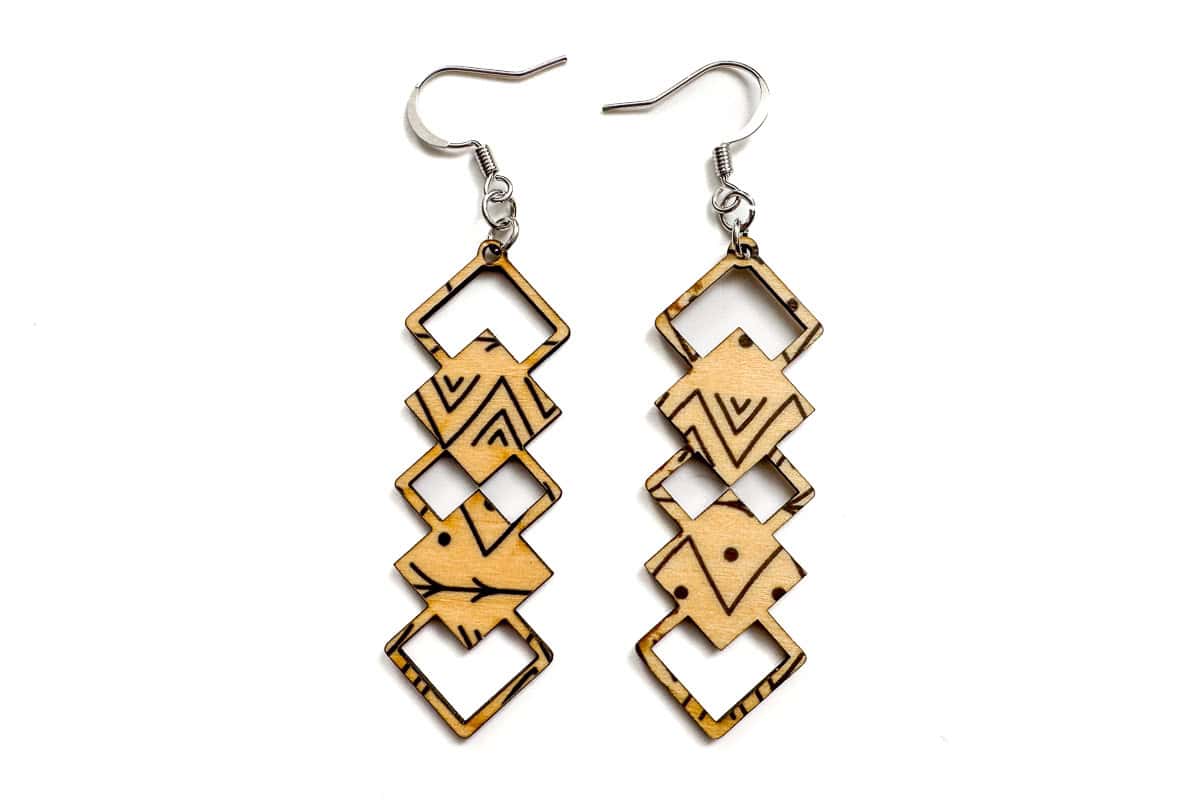 A pair of wood earrings cut with a laser.