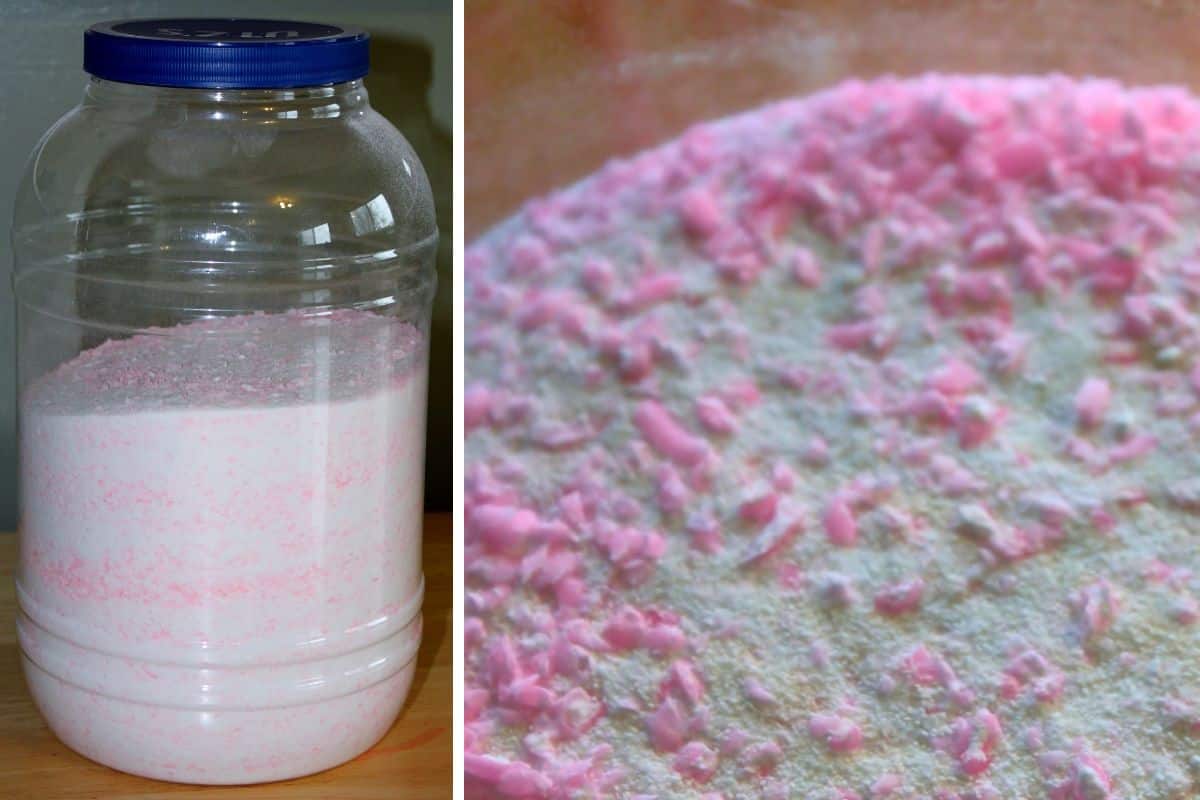 Large plastic container filled with homemade powdered laundry detergent, shown with pink and white speckled texture in a close-up view.