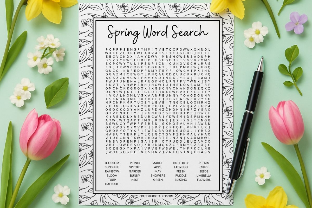 Flat lay of a spring-themed word search printable on a floral background with tulips, daffodils, and a pen, ready for a fun seasonal activity.