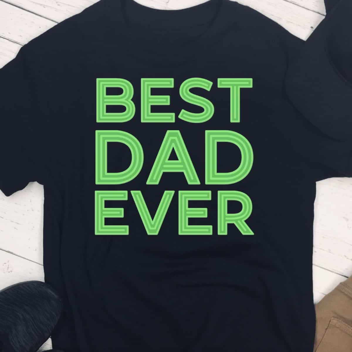 Black t-shirt with bold neon green text that reads “BEST DAD EVER,” styled in all caps and stacked in three centered lines.