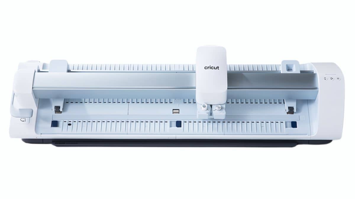 A Cricut Venture cutting machine in white and light blue, shown open with its wide cutting area and tool carriage visible.