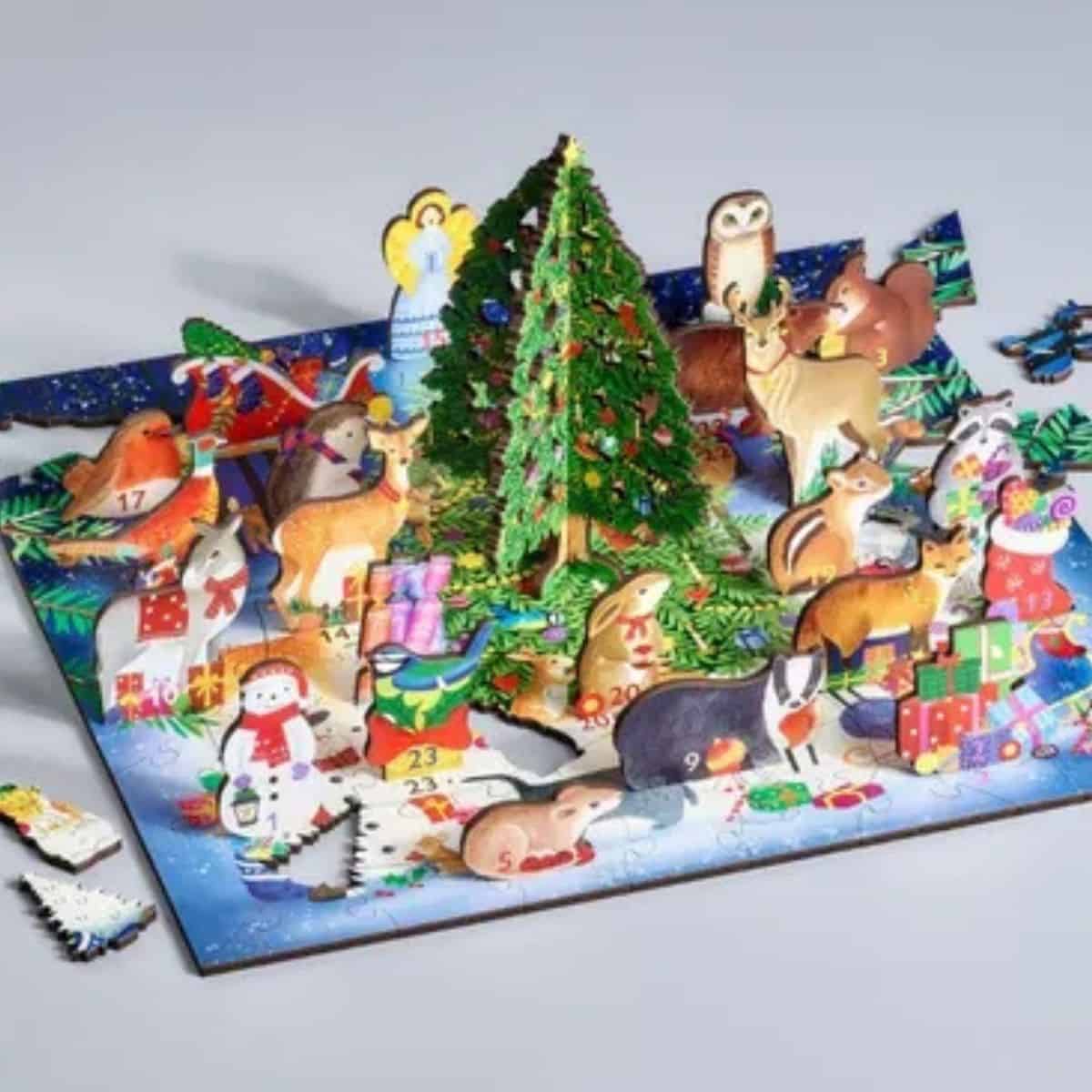 Festive advent calendar with animal figurines and a Christmas tree for holiday countdown.