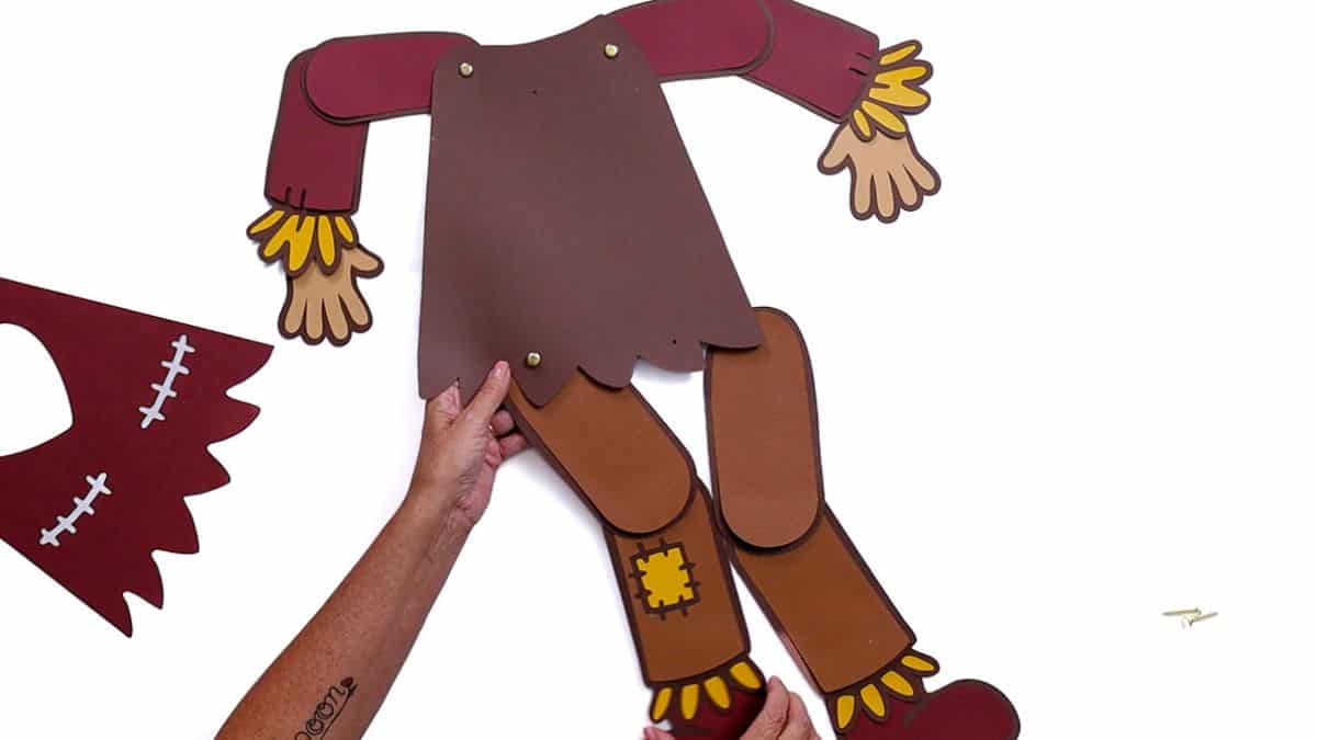 Attach the arms to the main body, aligning the holes with the body on top of the arms.