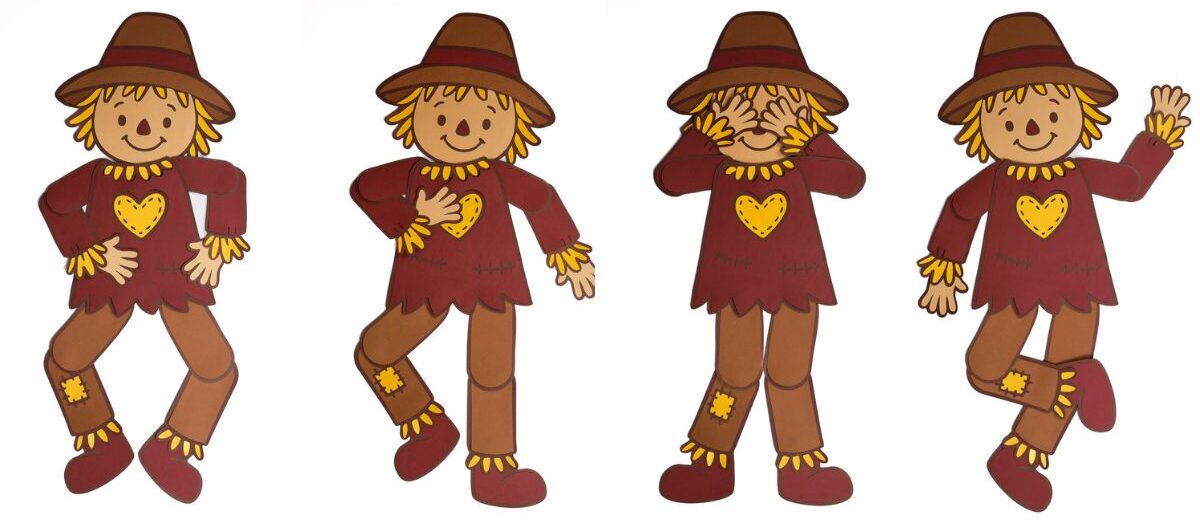 Four paper scarecrow cutouts with jointed arms and legs, wearing brown hats and red shirts with yellow hearts, posed in different playful positions.