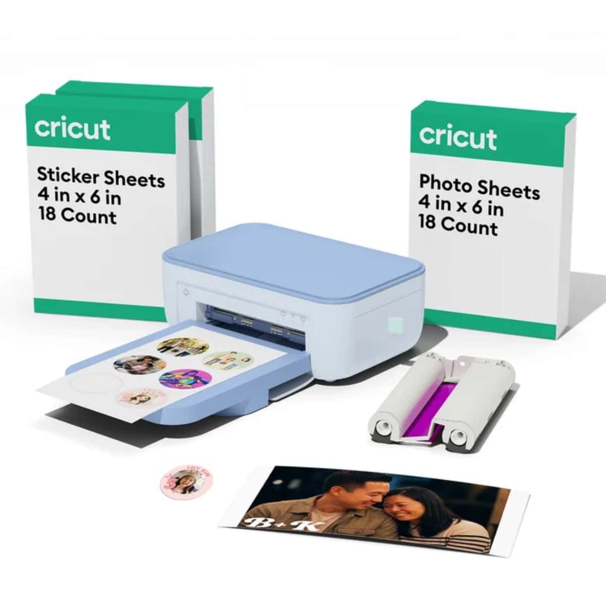 Cricut sticker and photo printer bundle with a light blue printer, sticker sheets, photo sheets, ink cartridges, and printed photos.