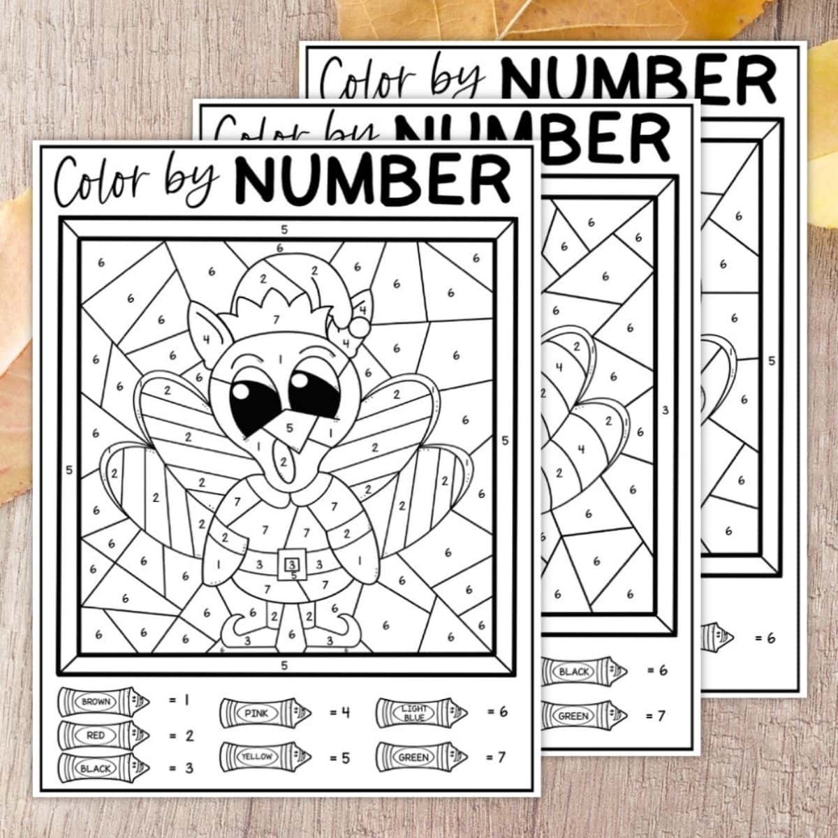 Three printable turkey color-by-number activity sheets for kids with crayons and numbered sections to guide coloring by color key.