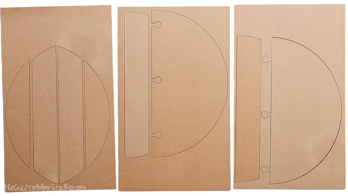 Laser cut MDF sheets showing pieces for assembling a round shiplap wood door hanger, including slatted and notched sections.