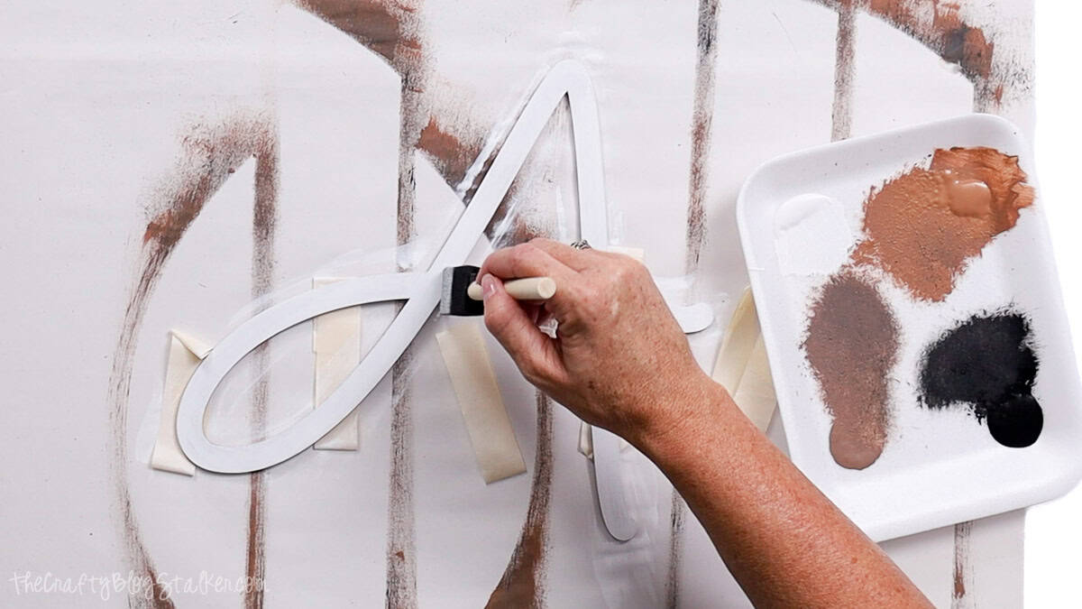 Hand painting a wooden letter 