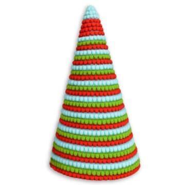 Colorful cone-shaped Christmas tree made from red, green, and blue pom pom trim arranged in neat horizontal stripes.