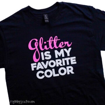 Finished T-shirt laid flat showing the Glitter Is My Favorite Color iron-on vinyl design centered on the front of the shirt.
