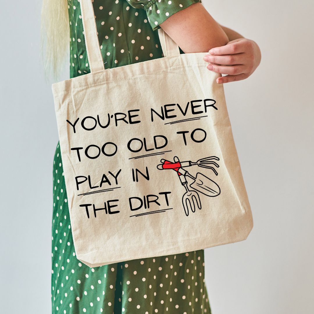 Person holding a canvas tote bag that reads