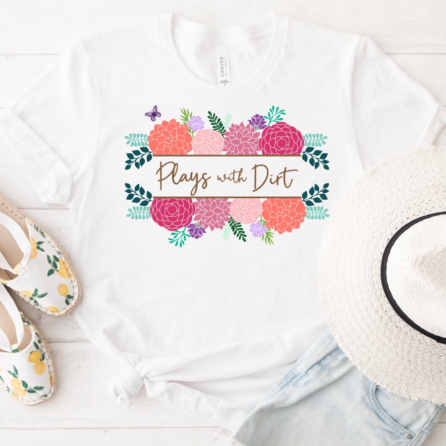 Flat lay of a white T-shirt with a floral design and the phrase