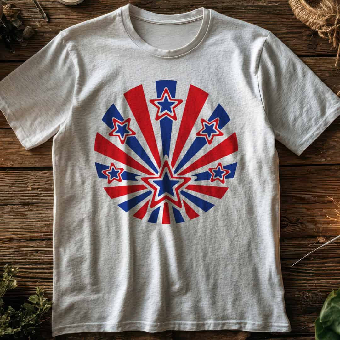 White T-shirt with a red, white, and blue starburst design featuring patriotic stars displayed on a rustic wood background.